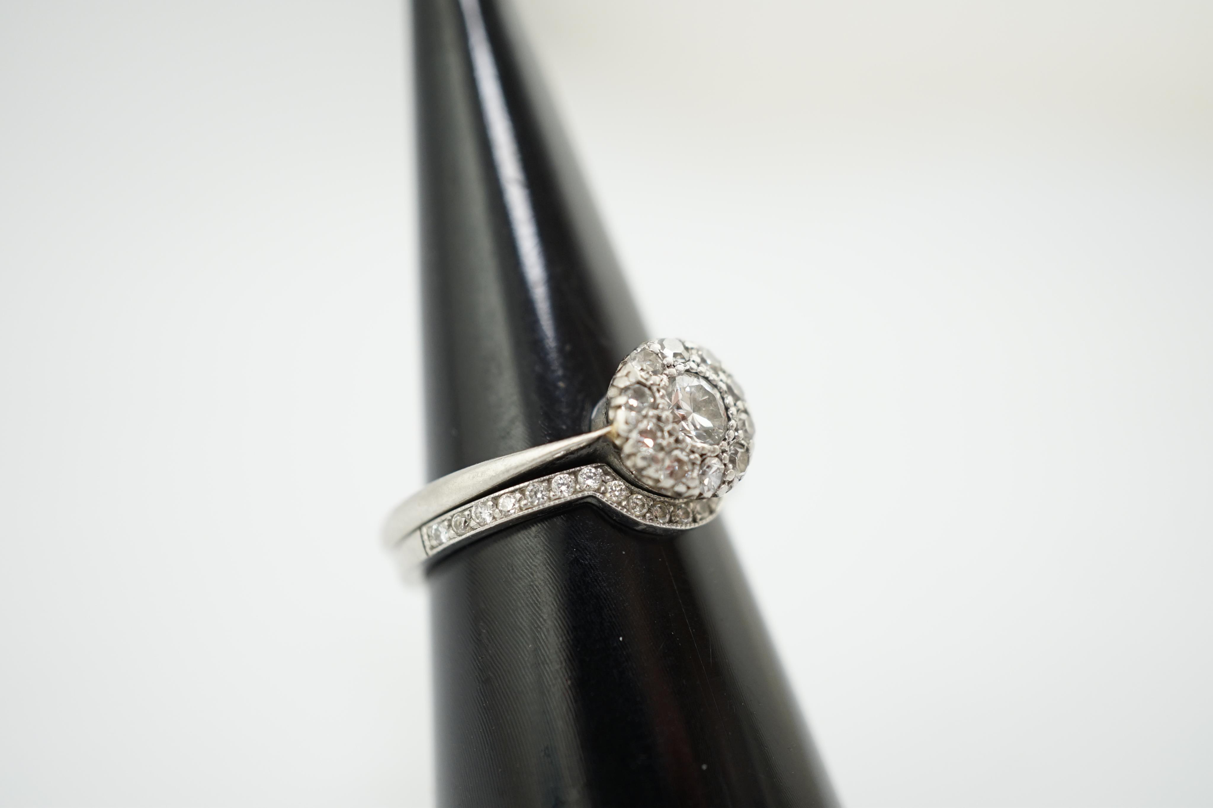 A mid 20th century and later platinum and diamond matched two piece wedding set